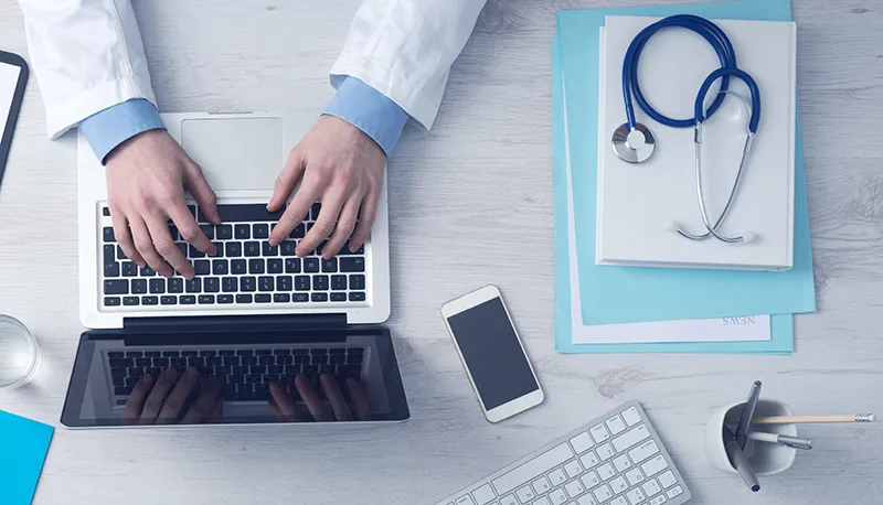 join-the-directory Thyroid Specialist making bioidentical hormone replacement therapy notes on laptop